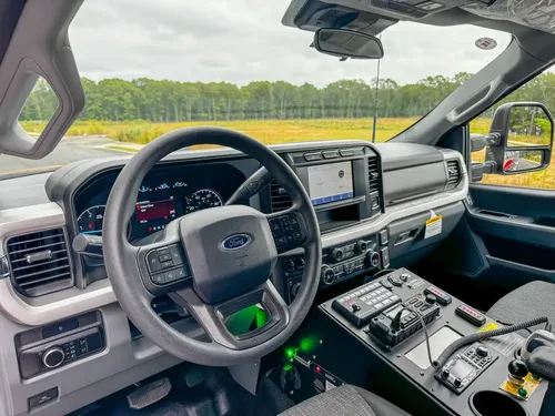 Passenger-side interior view showing dashboard, steering wheel, and console area.